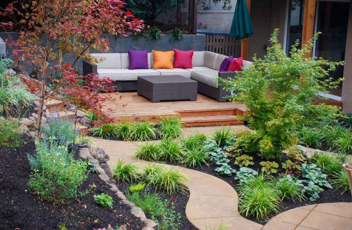 Scenic private garden and conversation area with colorful mix of plants and seating, with meandering walkways