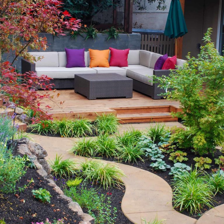Scenic private garden and conversation area with colorful mix of plants and seating, with meandering walkways Scenic private garden and conversation area with colorful mix of plants and seating, with meandering walkways